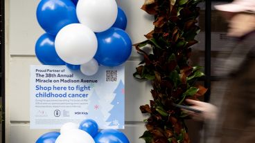A poster hung beneath blue and white balloons promotes the Miracle on Madison event, which supports MSK Kids cancer research. 