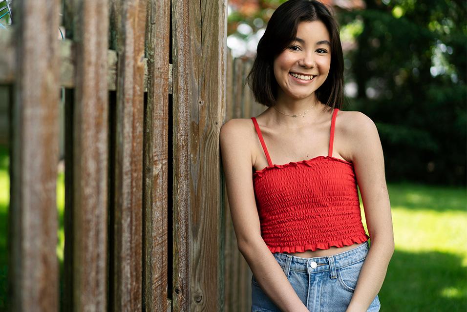MSK patient Giovanna Whitting leans against a fence, smiling.
