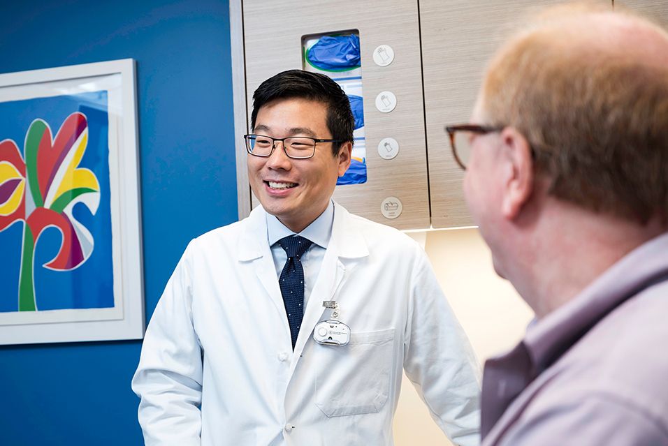 An MSK doctor speaks with a patient, representing the life-changing impact donors make possible through advanced cancer care and research. 