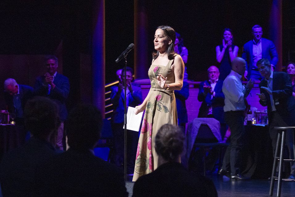 Comedy vs Cancer 2025 Honoree Carrie Goldberg speaking on stage.